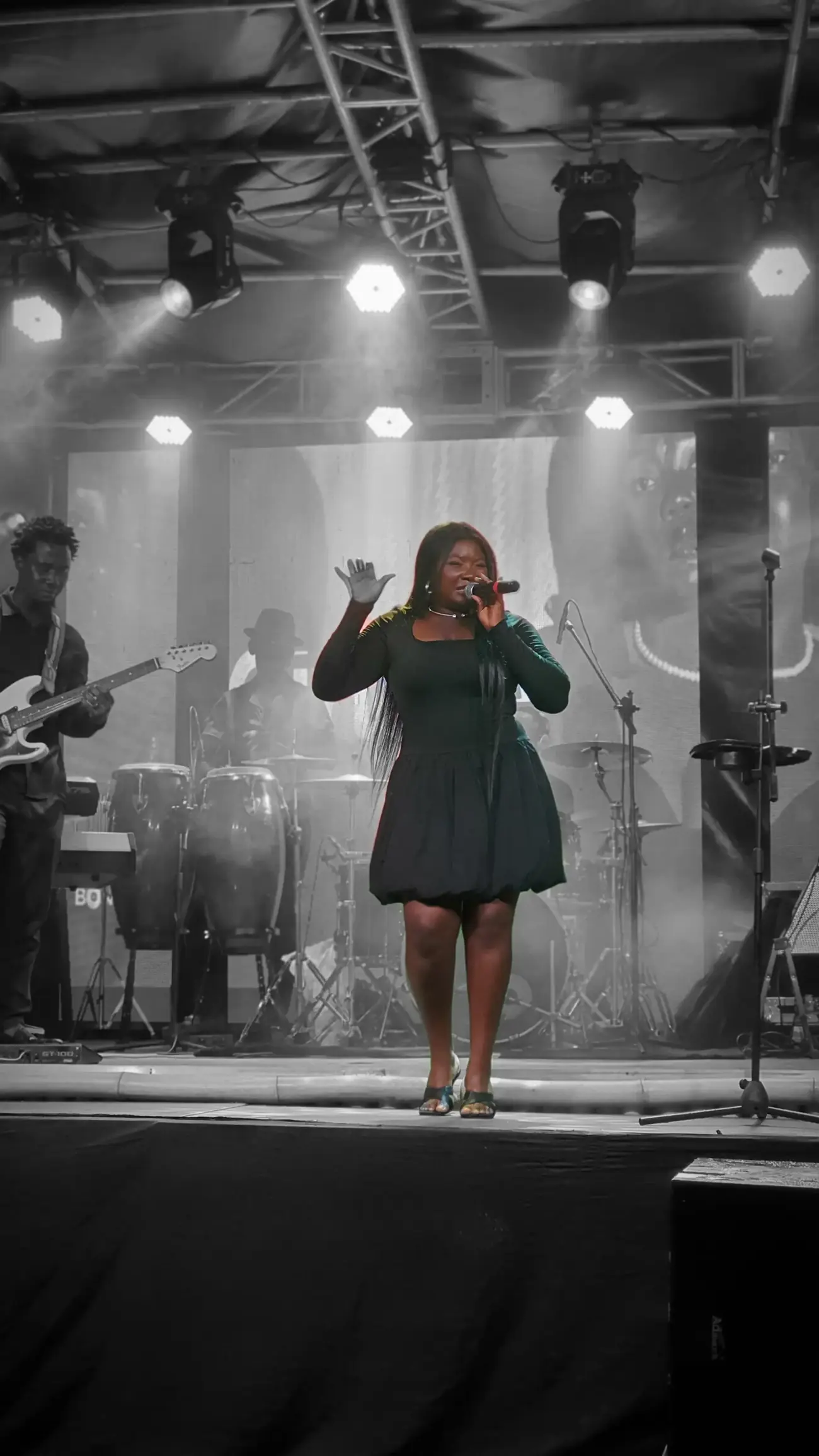 Gineve performing with a full band on a concert stage