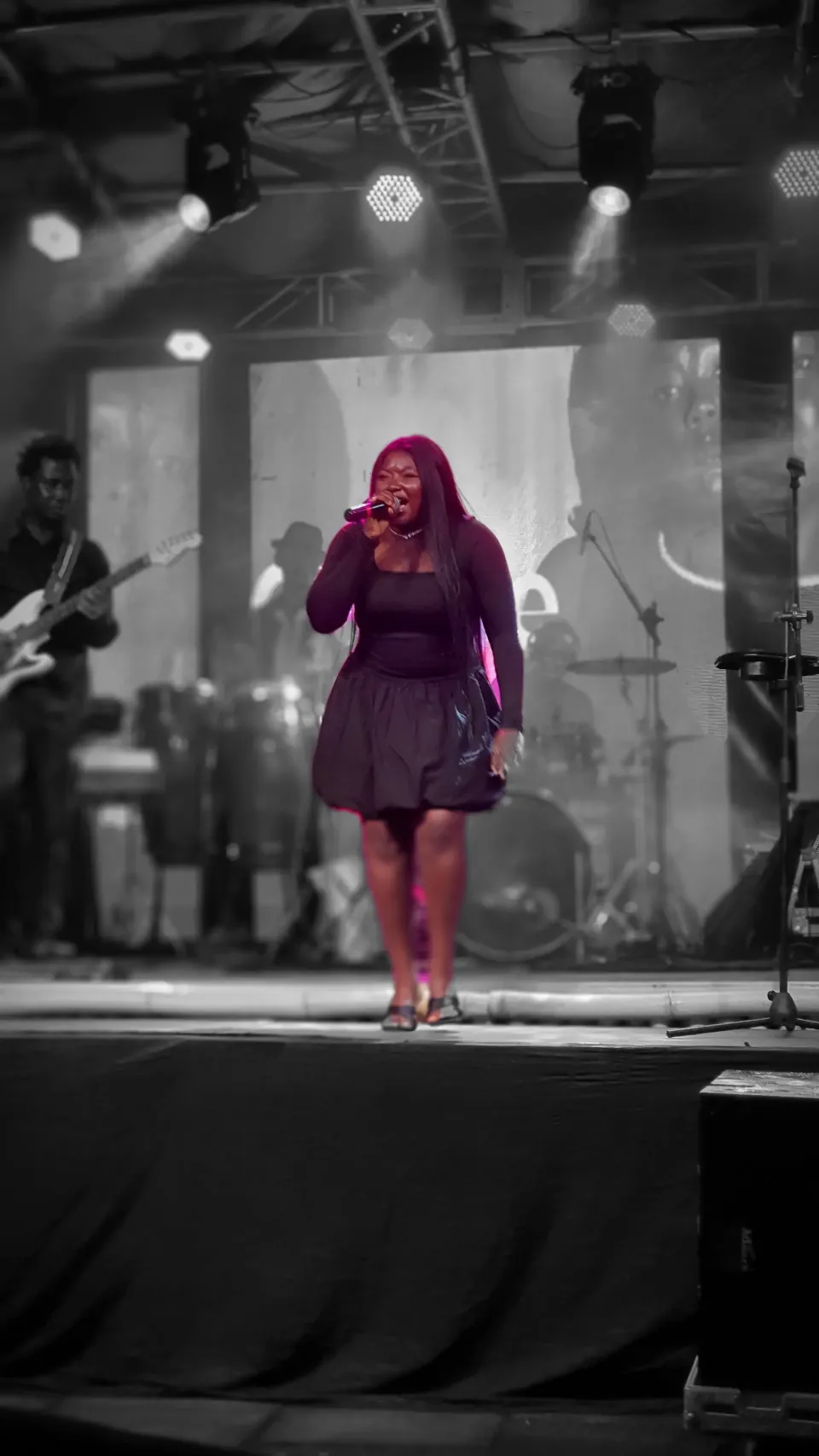 Gineve performing under stage lights